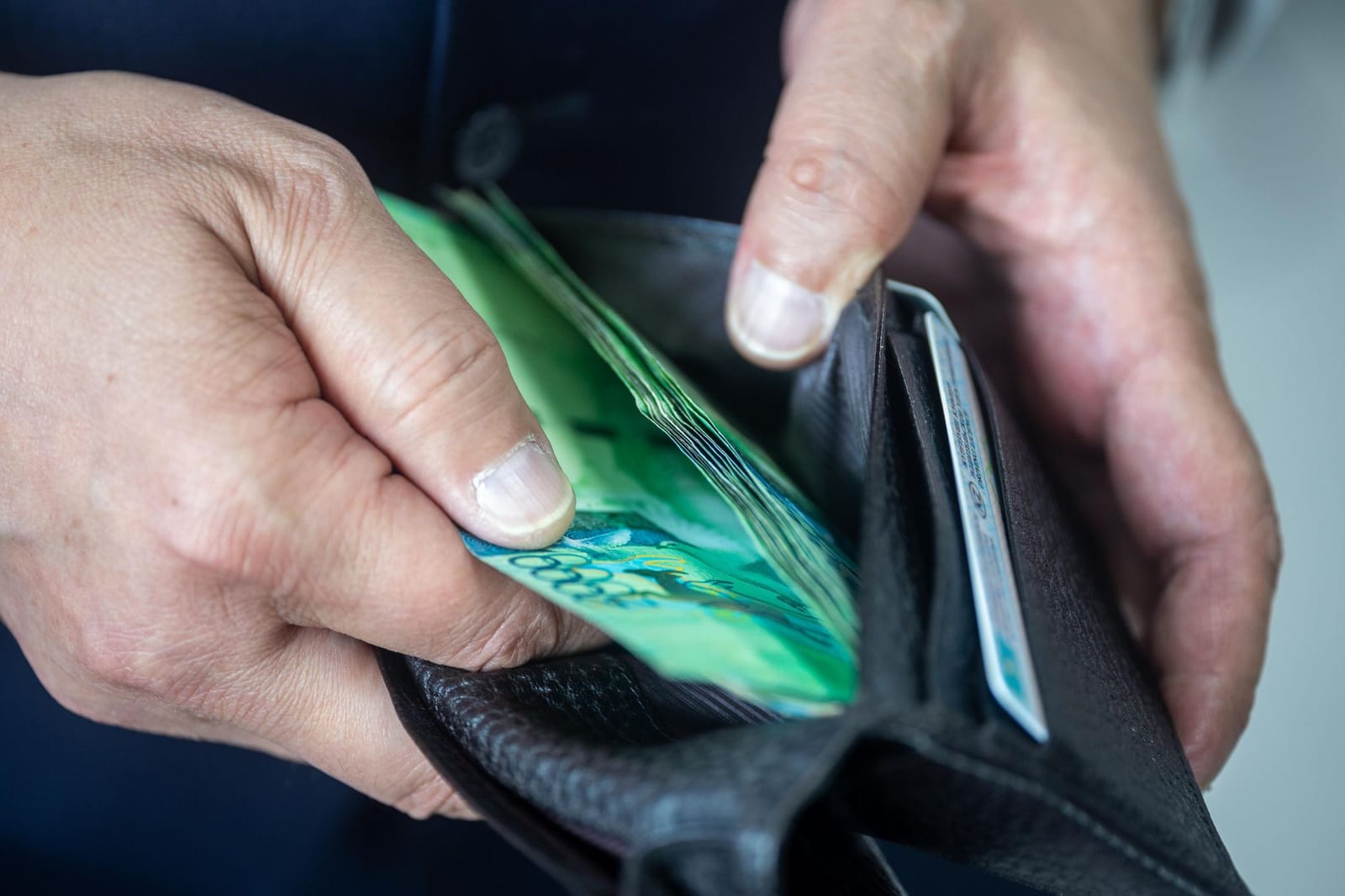 Handing over a small đồng note directly, the polite way to tip in Vietnam.